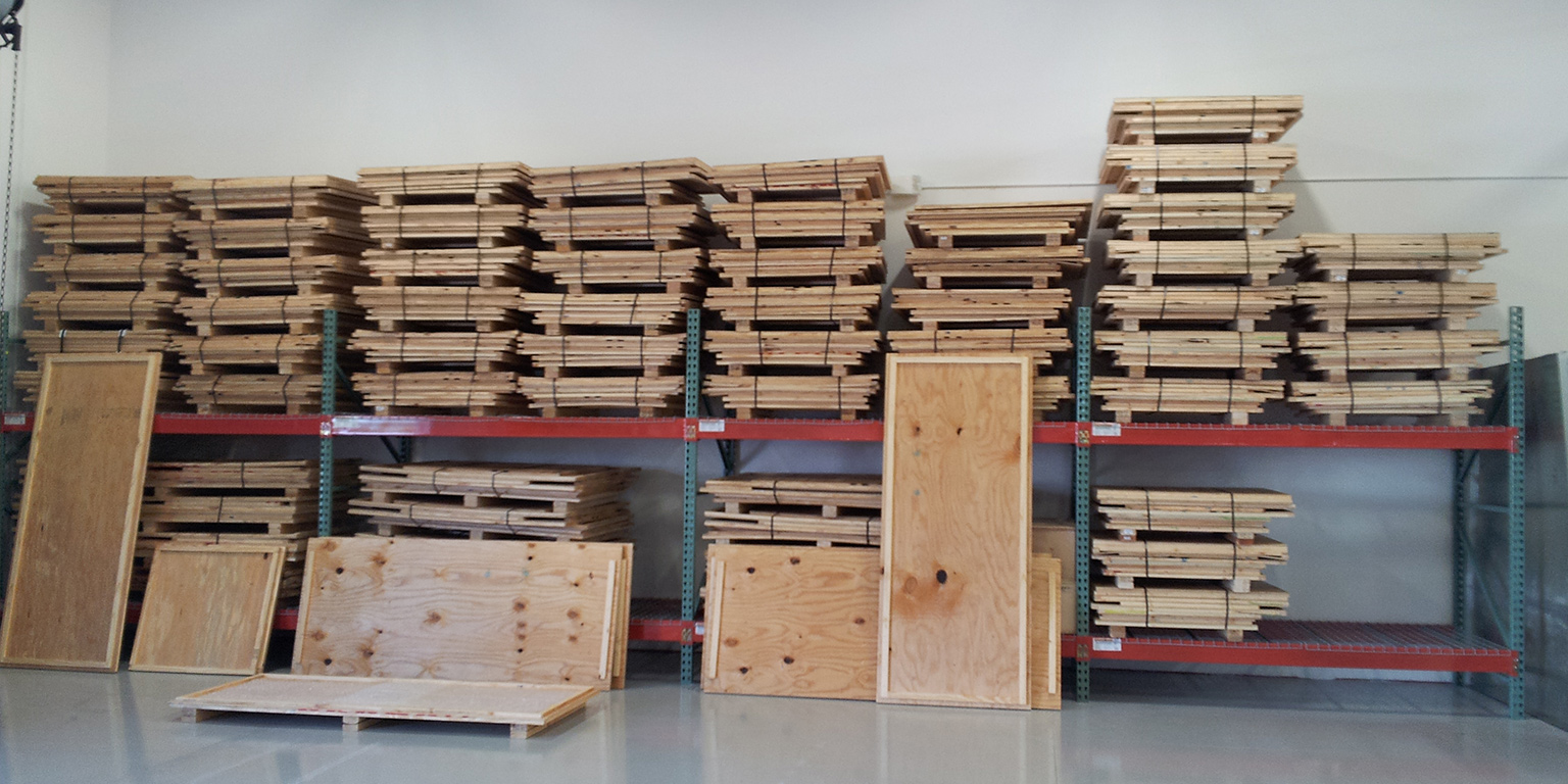 collapsible wooden crates stacked in a warehouse